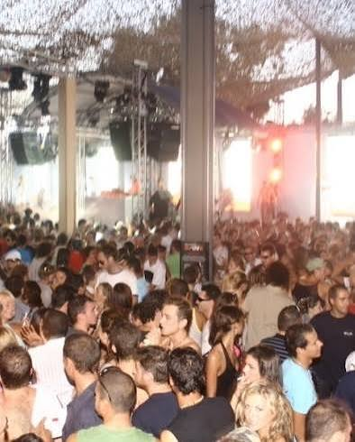 Crowded open-air Ibiza terrace party in the early 90s