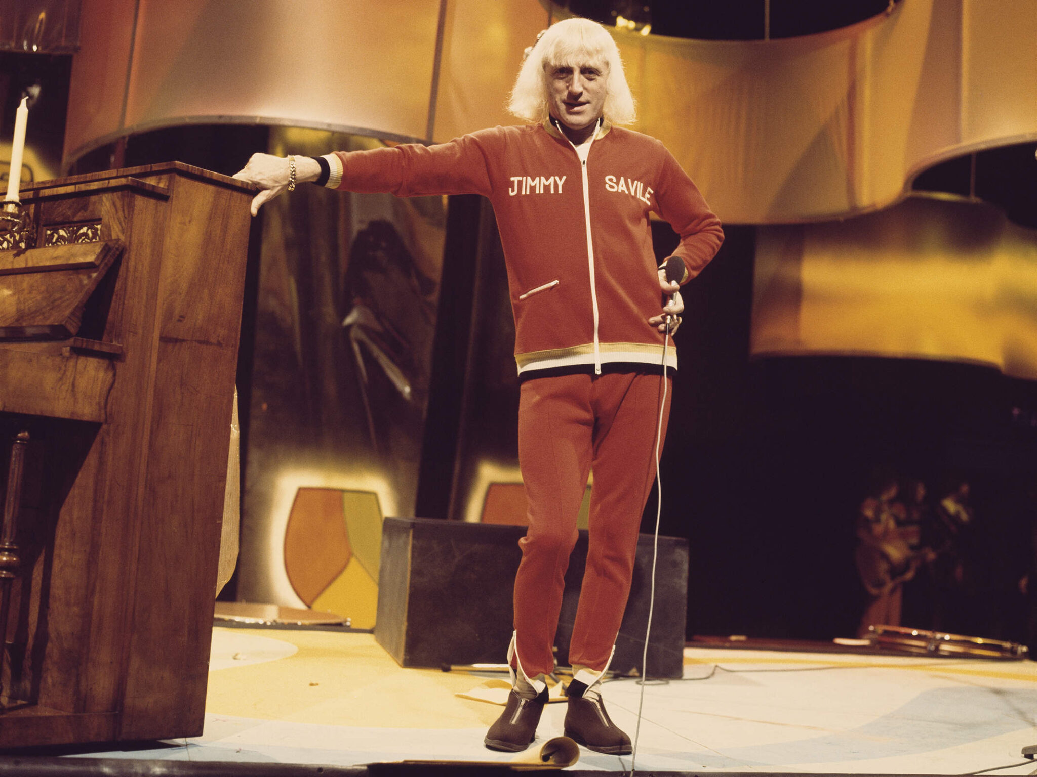 Jimmy Savile on Top of the Pops set in red tracksuit